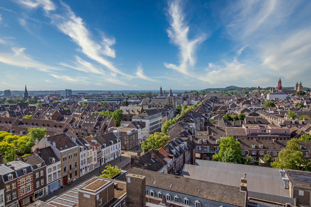 Aerial view of downtown Maastricht on a sunny day with blue skies, including houses on Boschstraat and Vrijthof