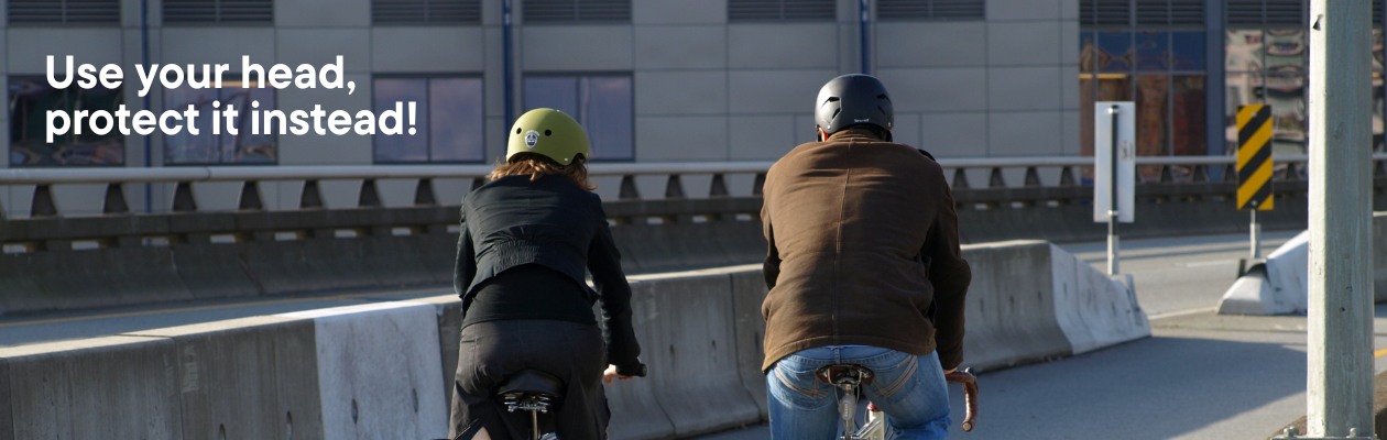 two people wearing helmets on a bike seen from the back, on the image is written: use your head, protect it instead!